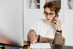 woman, bookkeeper, attentively talking on the phone from pexels user Karolina Grabowska